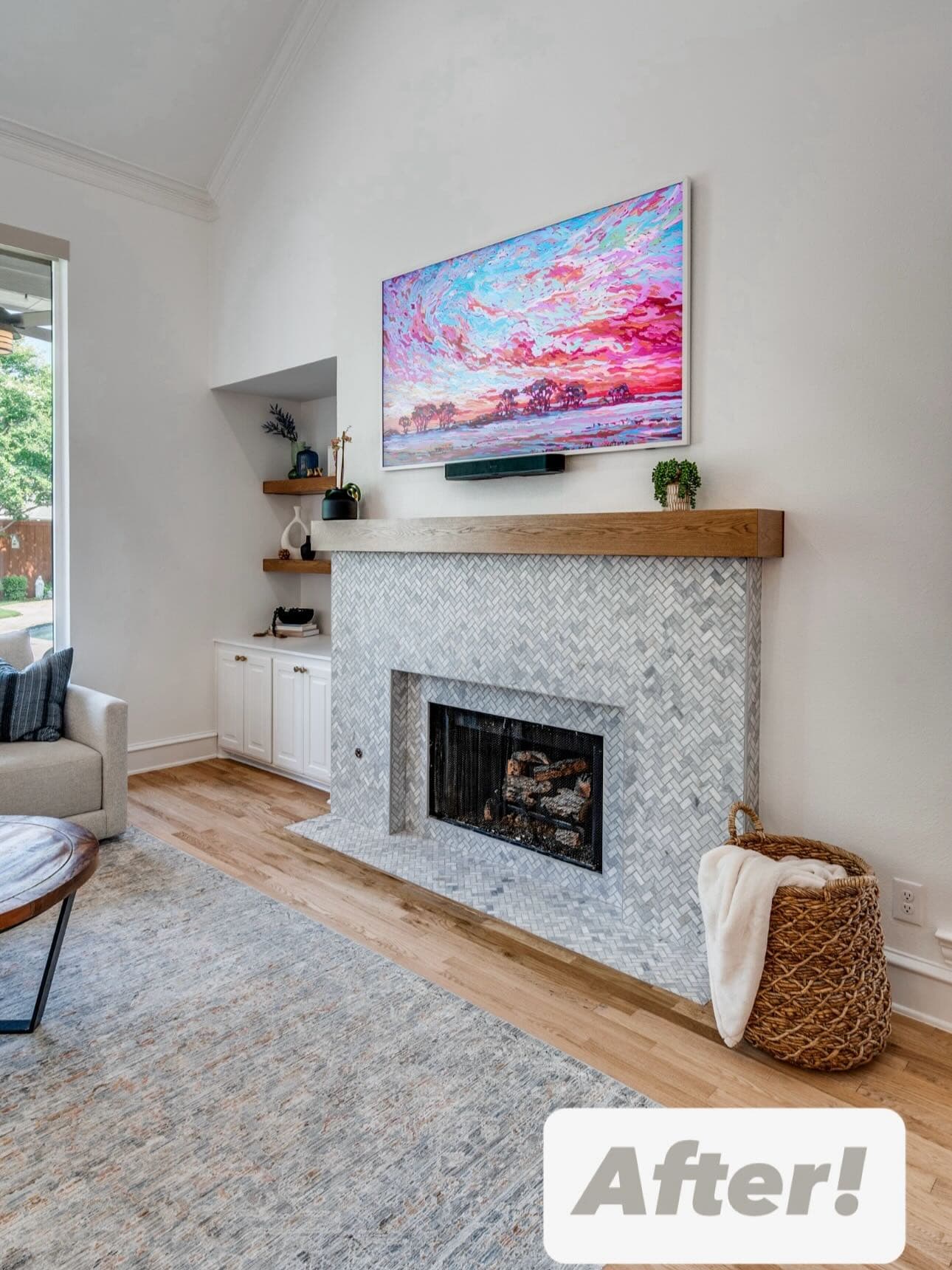 A finished fireplace wall with a herringbone stone surround, a timber mantel and recessed shelving beside it